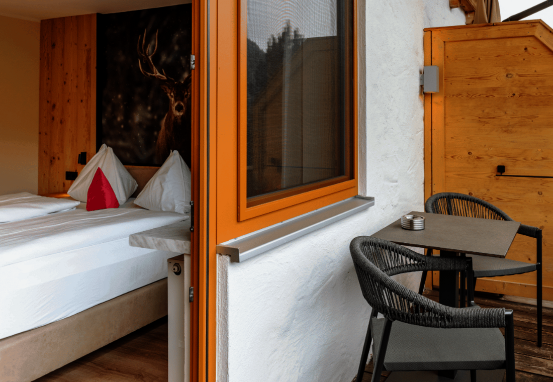 Doppelzimmer mit direktem Zugang zu einem möblierten Balkon